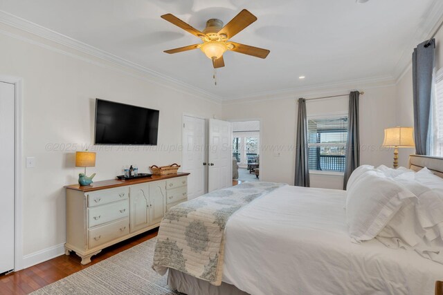 bedroom with baseboards, crown molding, a ceiling fan, and dark wood-style flooring