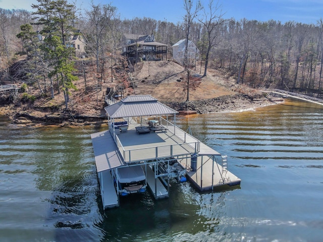 dock area with boat lift and a water view