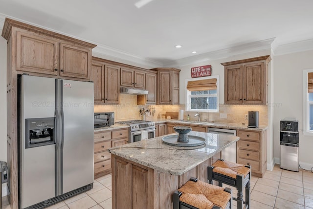 kitchen featuring light tile patterned flooring, backsplash, under cabinet range hood, and appliances with stainless steel finishes