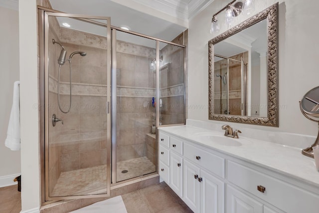 full bath with tile patterned floors, vanity, ornamental molding, and a shower stall