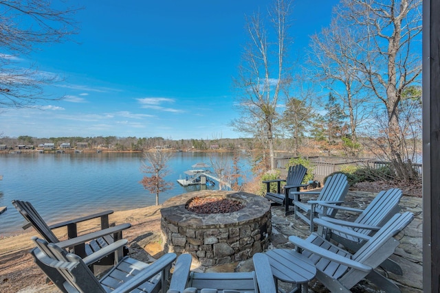 view of patio featuring a water view and a fire pit