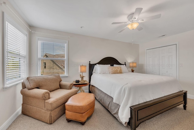 bedroom featuring baseboards, visible vents, a closet, and ceiling fan