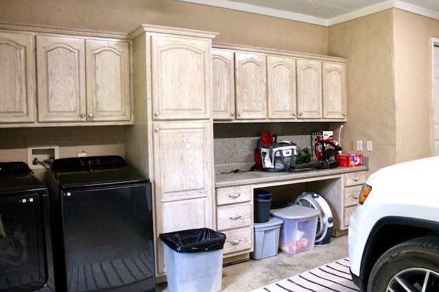 laundry room featuring washing machine and dryer, cabinet space, and ornamental molding
