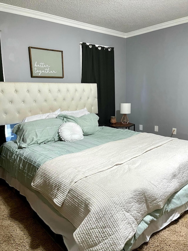 carpeted bedroom featuring ornamental molding and a textured ceiling