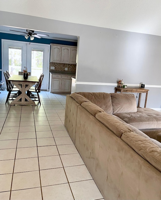living room featuring ceiling fan and light tile patterned floors