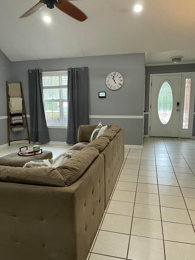 living room with a ceiling fan, light tile patterned floors, baseboards, lofted ceiling, and recessed lighting