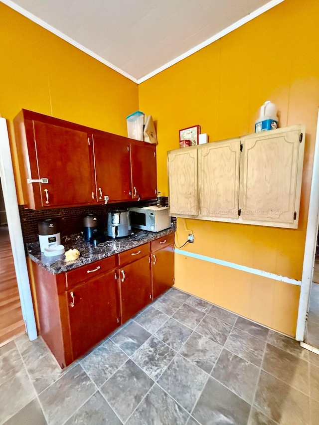 1902 Williams St, Jasper, AL 35501 - kitchen with crown molding, stone finish flooring, and white microwave