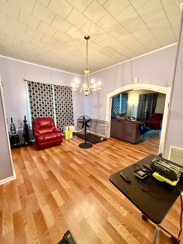 1902 Williams St, Jasper, AL 35501 - dining space featuring crown molding, wood finished floors, arched walkways, and a chandelier