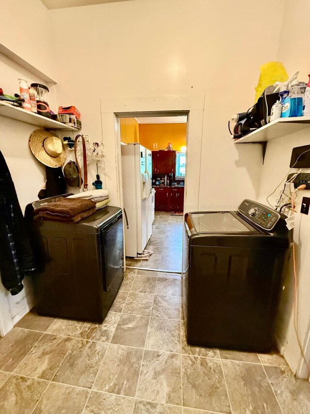 1902 Williams St, Jasper, AL 35501 - laundry room featuring washing machine and clothes dryer and light stone finish floors