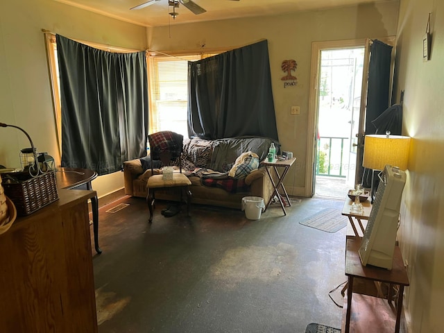 living area featuring concrete floors, a ceiling fan, and visible vents