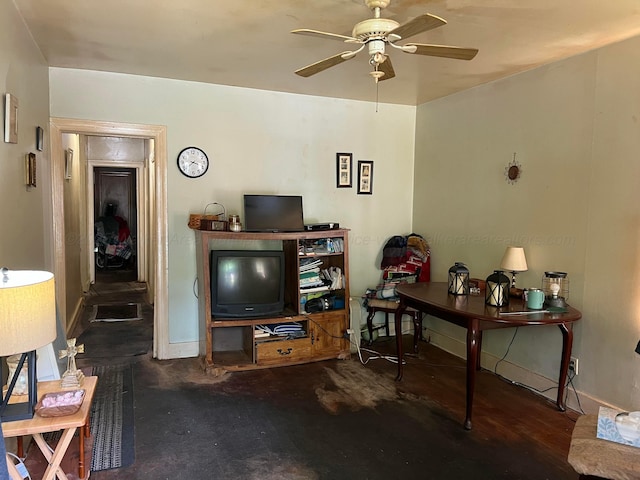 living room with ceiling fan and baseboards