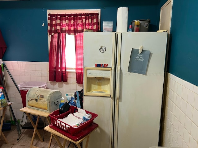 interior space with white fridge with ice dispenser and wainscoting