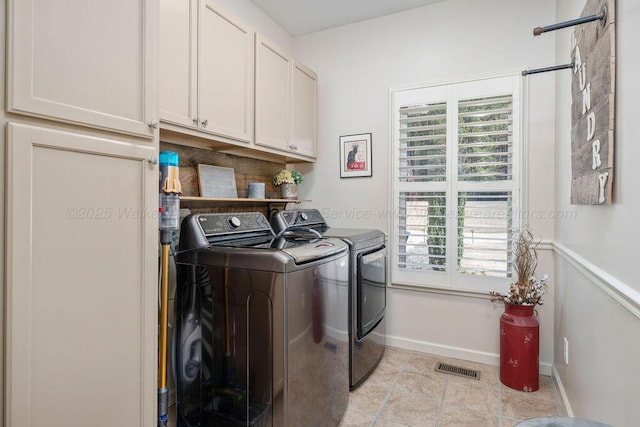 washroom featuring cabinet space, plenty of natural light, visible vents, and separate washer and dryer