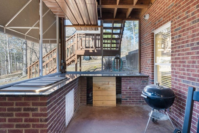 view of patio / terrace with stairway, area for grilling, and a sink