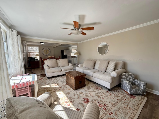 living area featuring ceiling fan, ornamental molding, wood finished floors, and baseboards