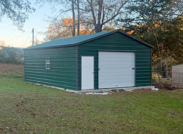 view of outbuilding featuring a garage and a yard