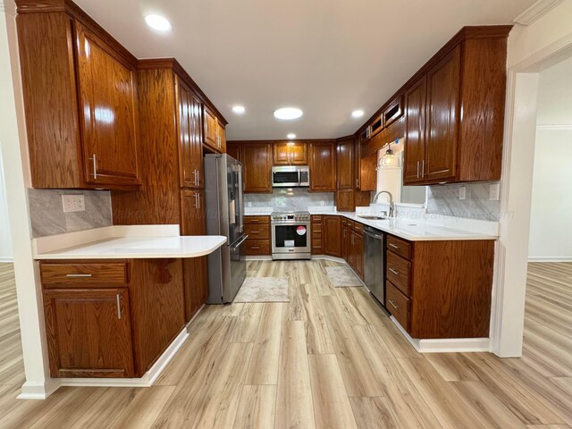 8502 Old Bagley Rd, Dora, AL 35062 - kitchen with premium appliances, light wood-style flooring, tasteful backsplash, light countertops, and recessed lighting