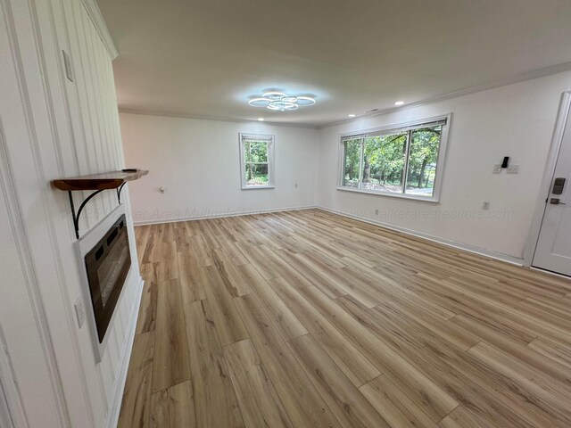 8502 Old Bagley Rd, Dora, AL 35062 - unfurnished living room featuring light wood-style floors, a large fireplace, heating unit, and recessed lighting