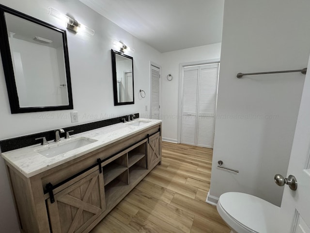 8502 Old Bagley Rd, Dora, AL 35062 - bathroom featuring wood finished floors, double vanity, and a closet