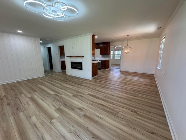8502 Old Bagley Rd, Dora, AL 35062 - unfurnished living room featuring a chandelier, crown molding, and light wood-style floors