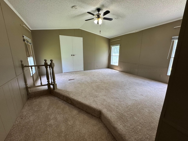 8502 Old Bagley Rd, Dora, AL 35062 - unfurnished bedroom with vaulted ceiling, crown molding, carpet, a decorative wall, and a textured ceiling