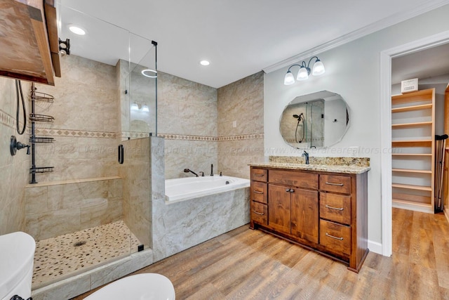 bathroom featuring hardwood / wood-style floors, vanity, independent shower and bath, and ornamental molding