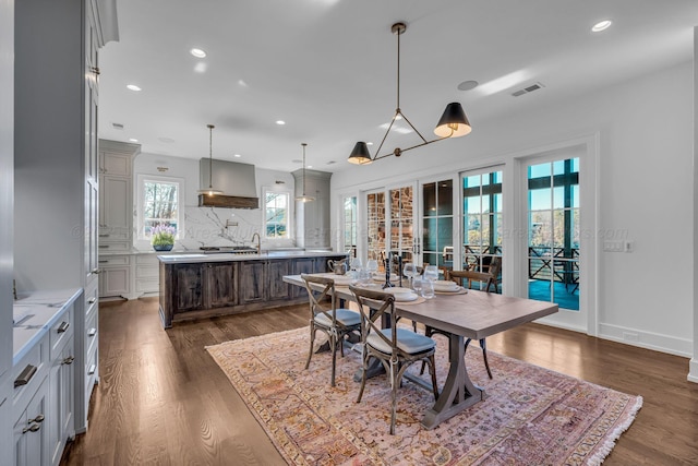 dining space featuring dark wood-style floors, visible vents, baseboards, and recessed lighting