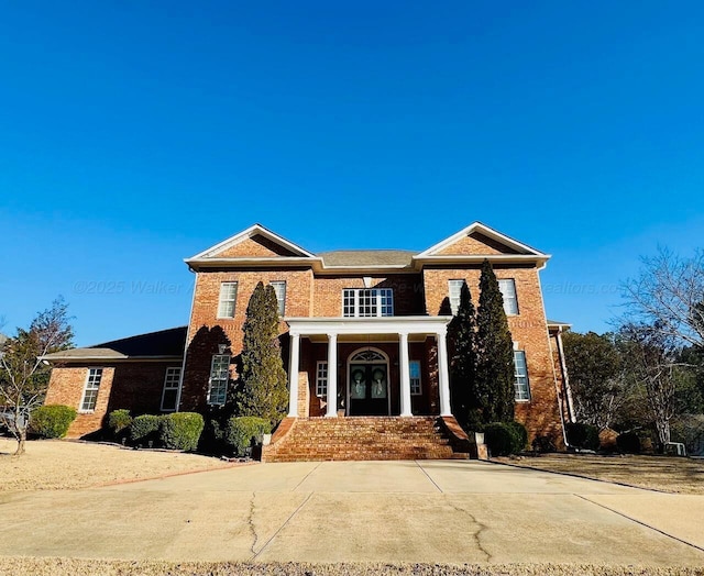 view of front of property with brick siding and french doors