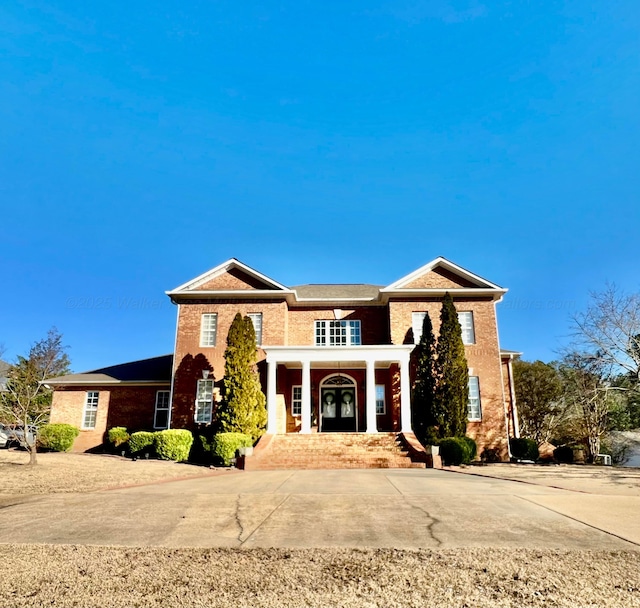 view of front of house featuring french doors and brick siding