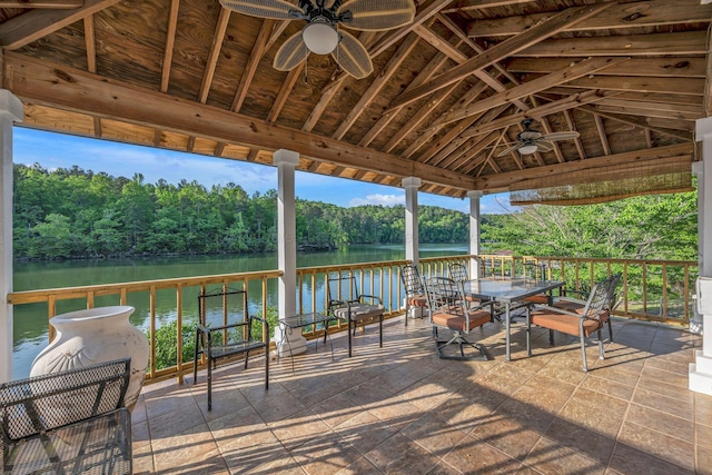 view of patio / terrace featuring a water view, ceiling fan, a forest view, and a gazebo