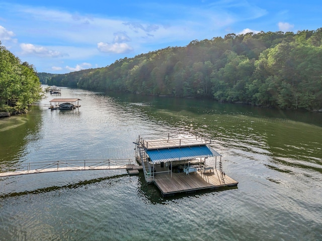 dock area with a water view and a wooded view