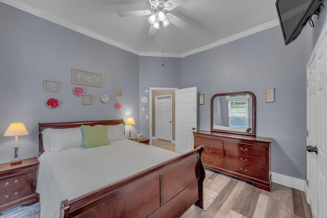 bedroom featuring baseboards, ornamental molding, ceiling fan, and wood finished floors