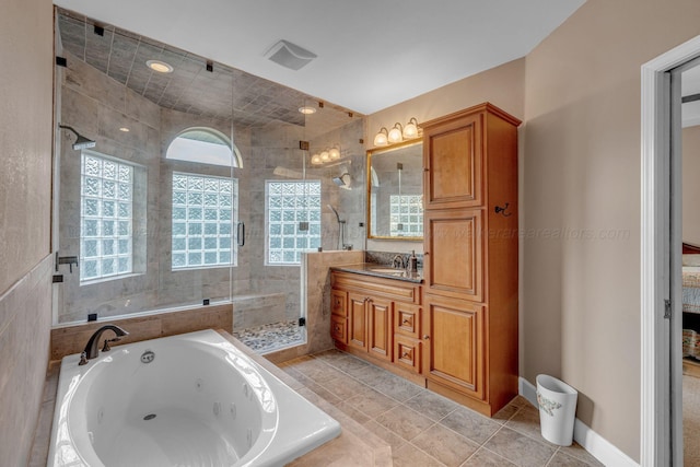 bathroom with a tub with jets, tile patterned flooring, vanity, and a shower stall