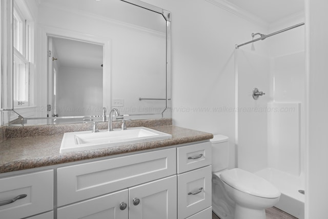 full bath featuring vanity, crown molding, toilet, plenty of natural light, and a stall shower