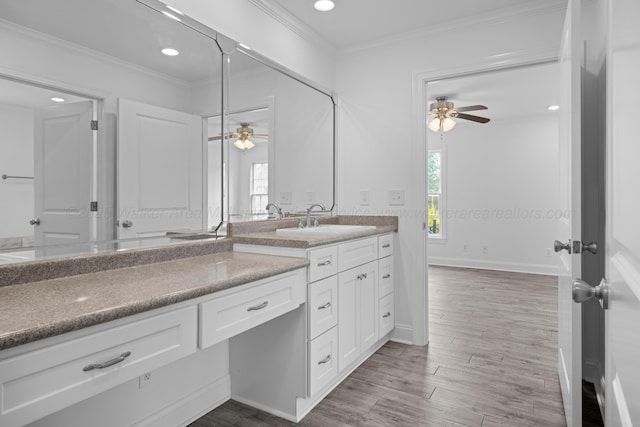 bathroom with vanity, crown molding, recessed lighting, ceiling fan, and wood finished floors