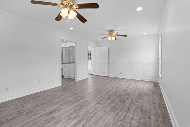 spare room with baseboards, wood finished floors, ceiling fan, and ornamental molding