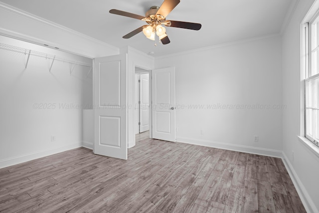 unfurnished bedroom with ornamental molding, wood finished floors, and multiple windows