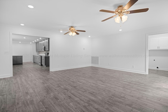unfurnished living room featuring visible vents, baseboards, wood finished floors, recessed lighting, and a ceiling fan