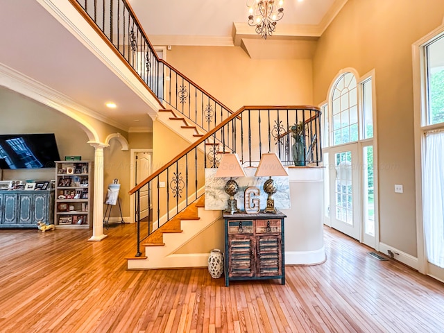 1000 Foothill Rd, Winfield, AL 35594 - foyer with decorative columns, hardwood / wood-style floors, a high ceiling, baseboards, and ornamental molding