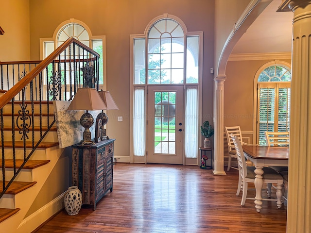 1000 Foothill Rd, Winfield, AL 35594 - foyer with a towering ceiling, arched walkways, wood-type flooring, baseboards, and stairway