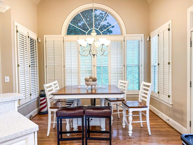 1000 Foothill Rd, Winfield, AL 35594 - dining area with a chandelier, light wood finished floors, baseboards, and vaulted ceiling