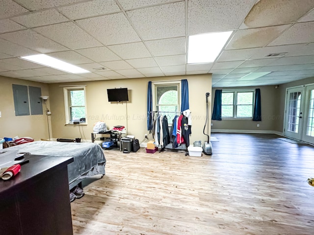 1000 Foothill Rd, Winfield, AL 35594 - bedroom featuring wood finished floors, a drop ceiling, baseboards, electric panel, and access to outside