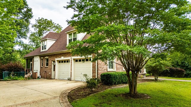 1000 Foothill Rd, Winfield, AL 35594 - view of front facade with driveway, brick siding, a front lawn, and a garage
