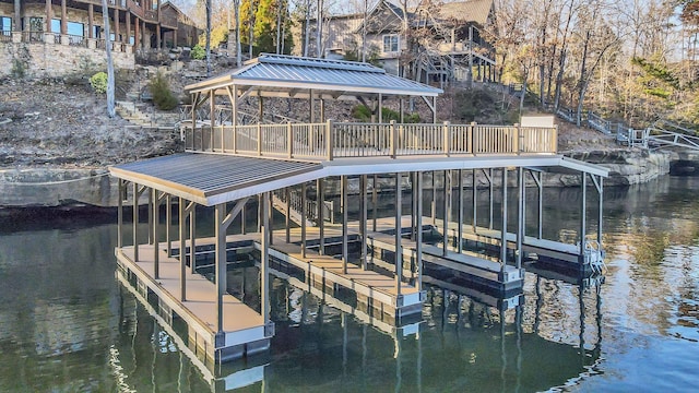 dock area with a water view and boat lift