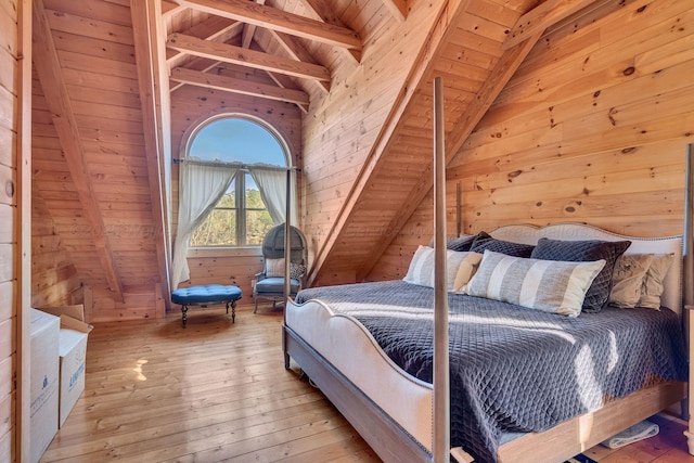 bedroom with lofted ceiling with beams, wooden ceiling, wooden walls, and light wood finished floors