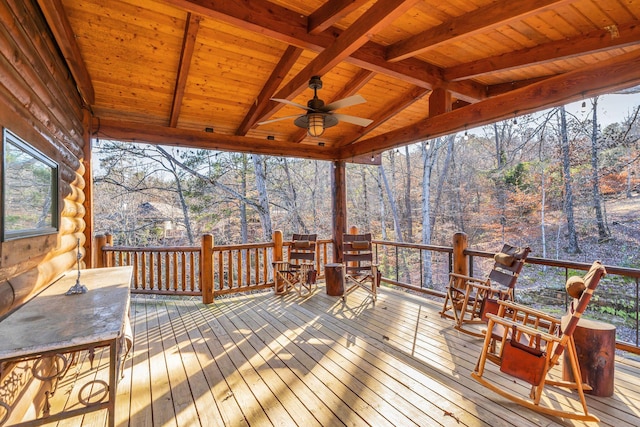 wooden deck featuring outdoor dining space and ceiling fan