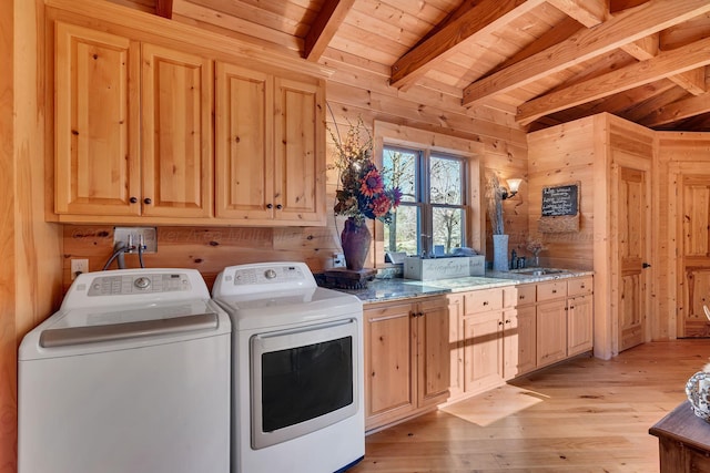 laundry room featuring separate washer and dryer, wooden walls, light wood-type flooring, cabinet space, and wooden ceiling