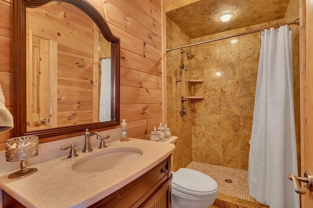 bathroom featuring toilet, vanity, wooden walls, and tiled shower