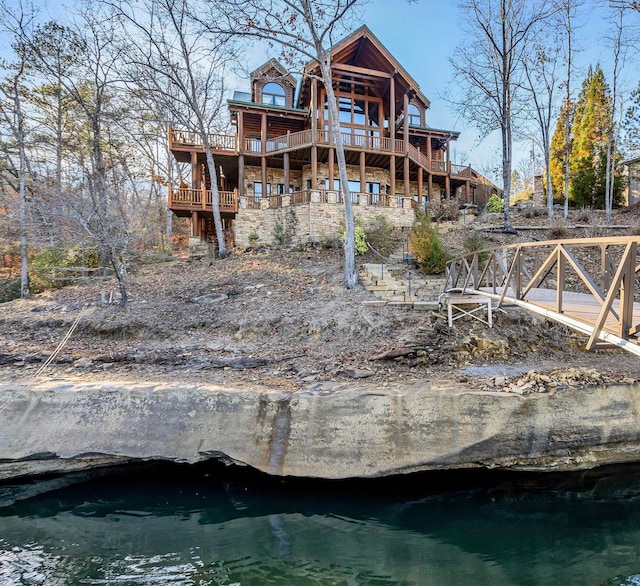 back of house featuring a deck with water view