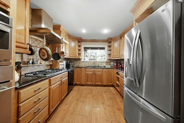 kitchen featuring a sink, open shelves, light wood-type flooring, exhaust hood, and stainless steel appliances